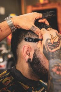 man in black shirt with tattoo on his left arm